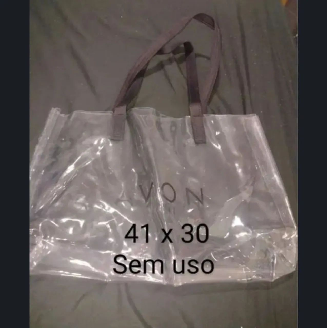Bolsa transparente marca Avon 