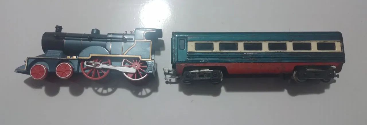 Trem de lata e vagão antigos.