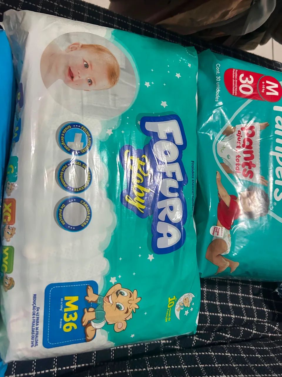 4 pacotes de fraldas vendo ou troco por XG - Foto 2