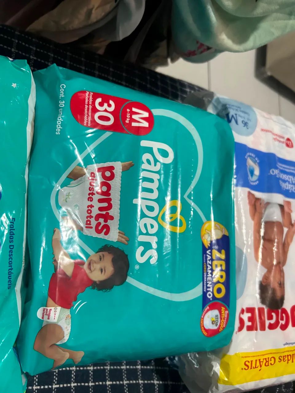 4 pacotes de fraldas vendo ou troco por XG - Foto 3