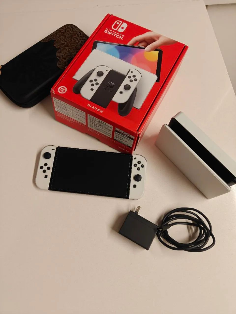 Nintendo Switch OLED usado, na caixa com acessórios e case do Zelda TOTK