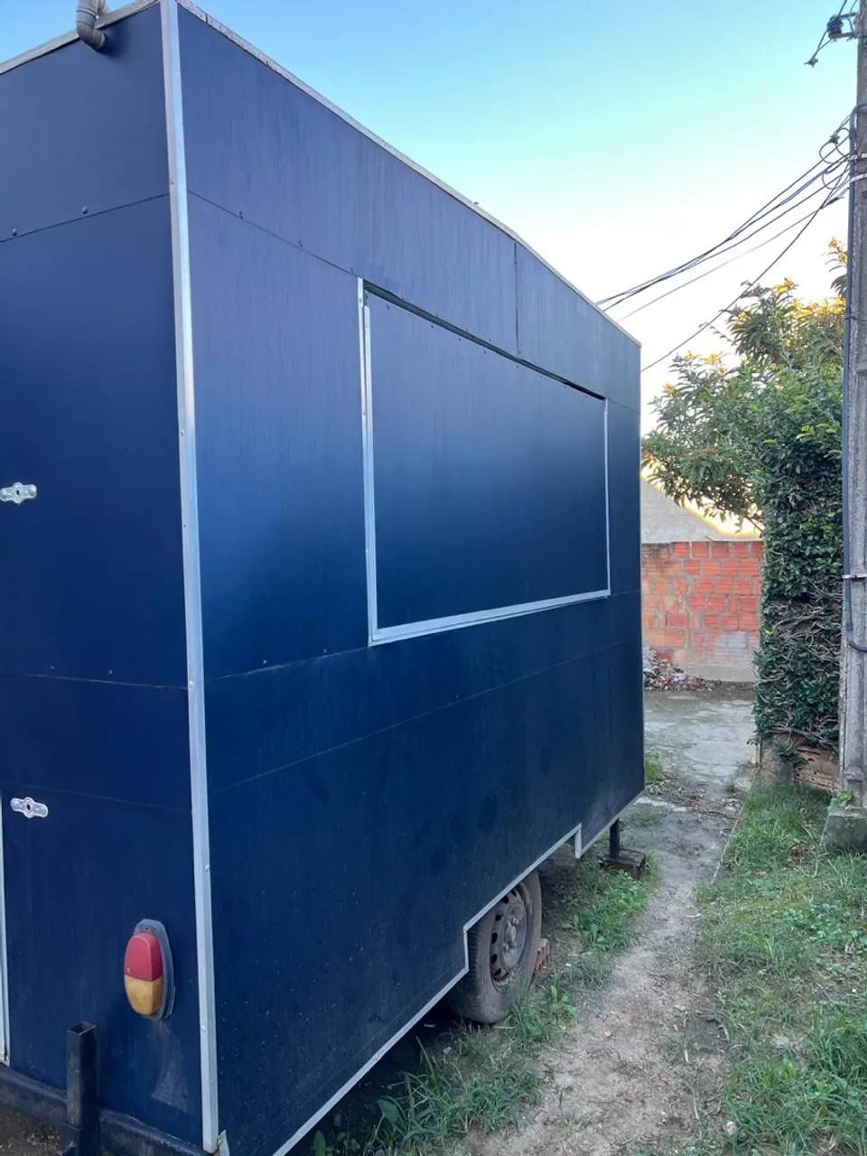 Trailer parked in a secure, fenced area, highlighting the importance of safe storage during rental periods