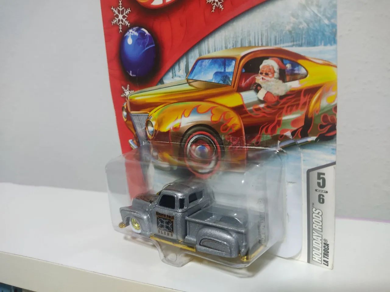 HOT WHEELS LA TROCA HOLIDAY RODS (LEIA) - Hobbies e coleções