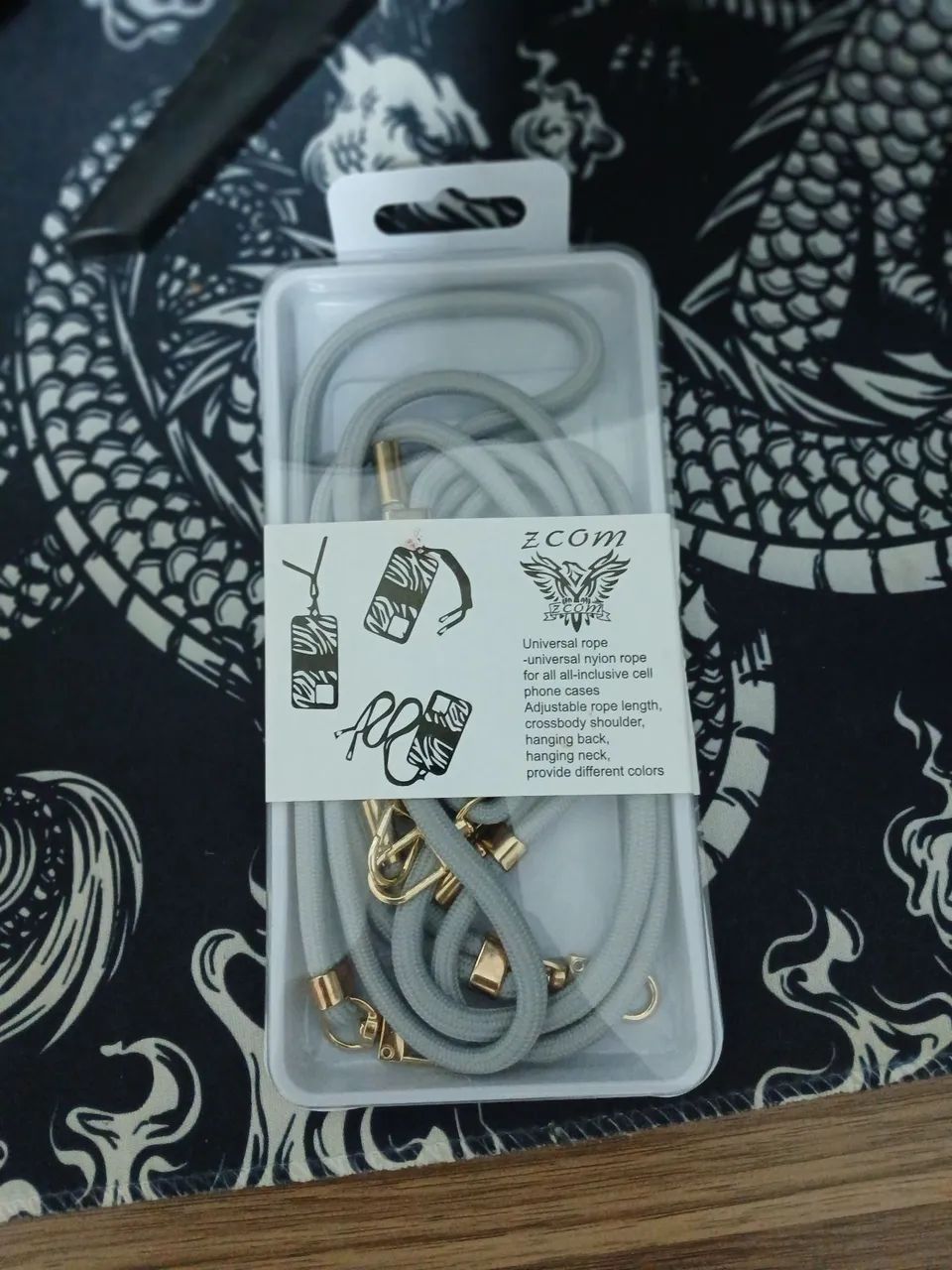  Vende-se Cordão Universal para Celular ZCOM - Cinza e Dourado