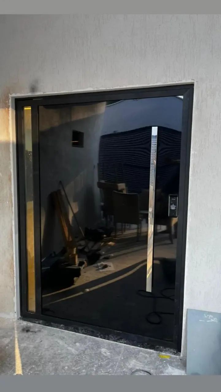 Porta de entrada em acm preto com puxador de aço inox