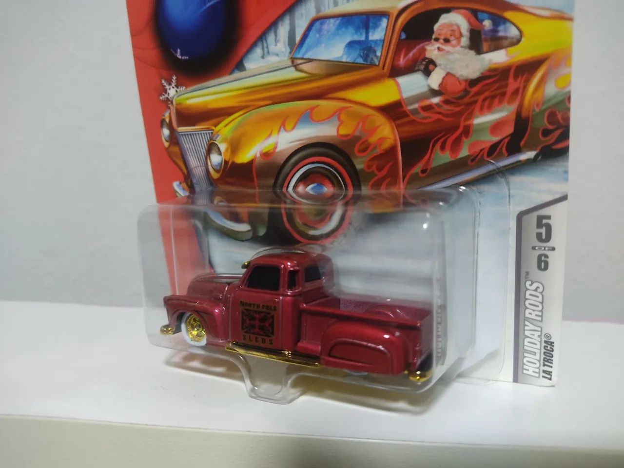 HOT WHEELS LA TROCA HOLIDAY RODS (LEIA) - Hobbies e coleções