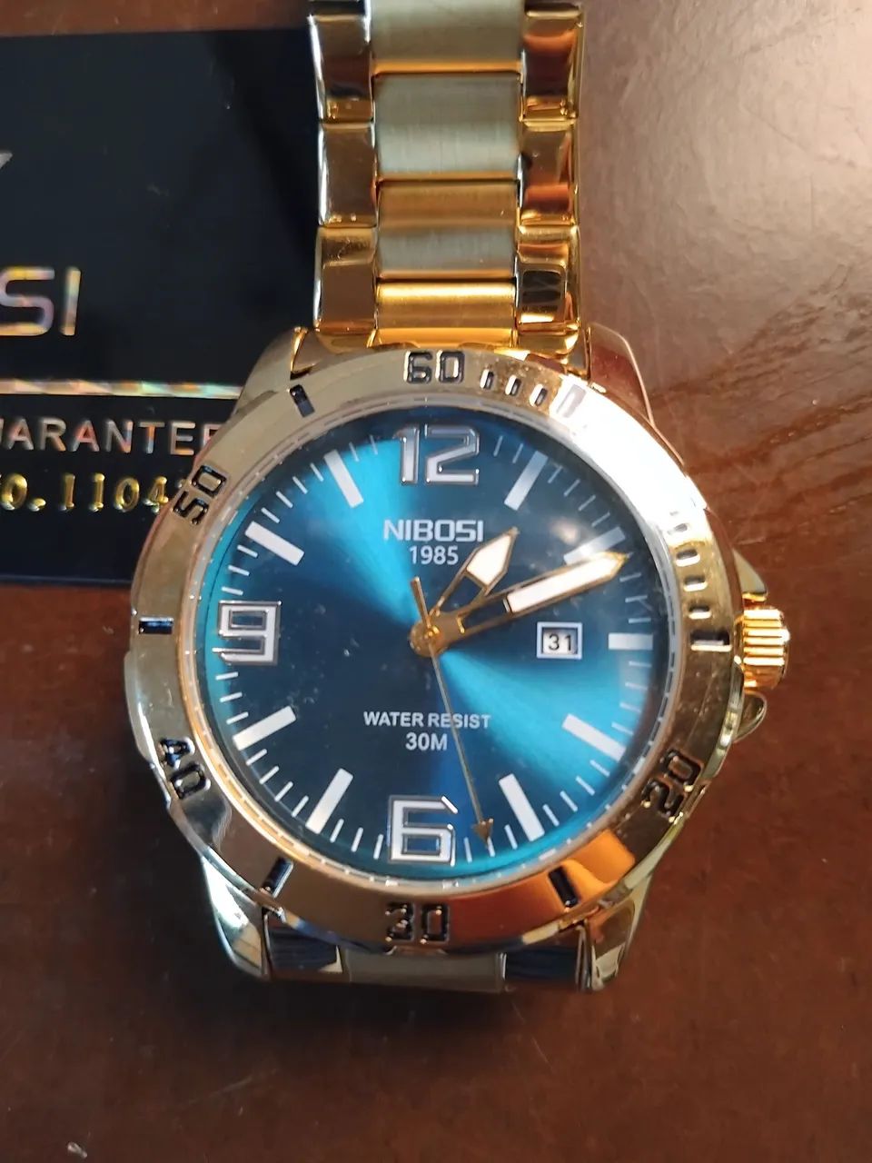Relogio nibosi dourado 