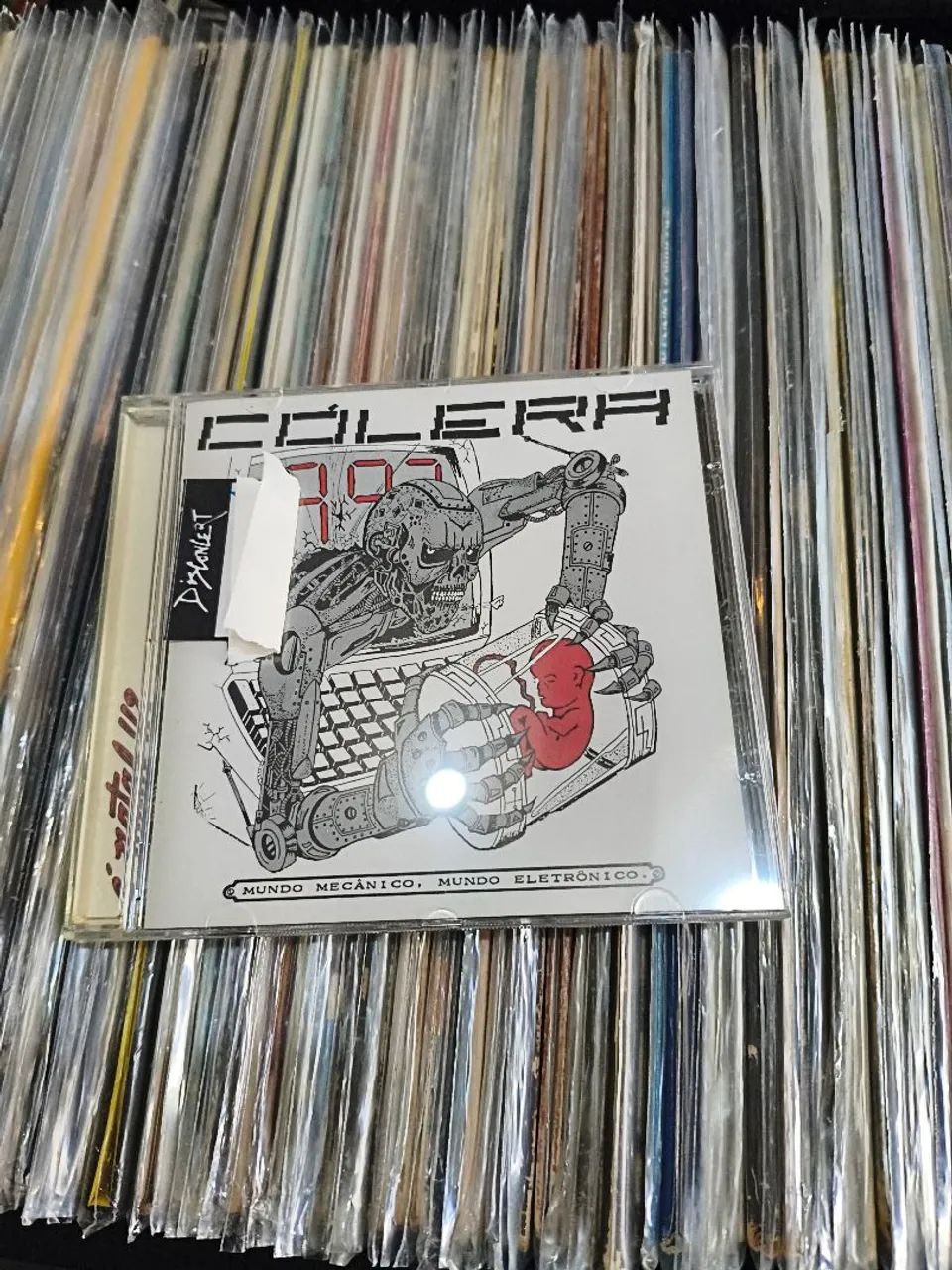 CD Cólera - Mundo Mecânico, Mundo Eletrônico