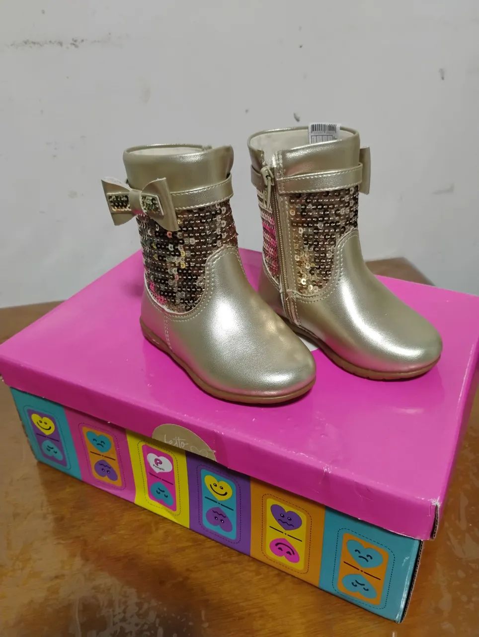 Botas infantis douradas com brilho e laço
