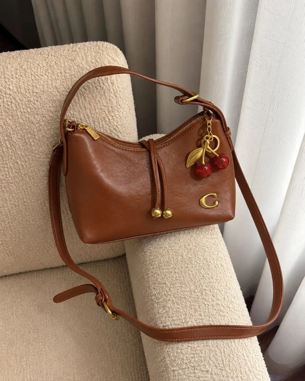 Bolsa Coach com chaveiro 