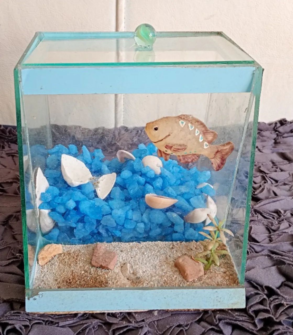 Aquario de vidro com decoração, pedraria e tampa.