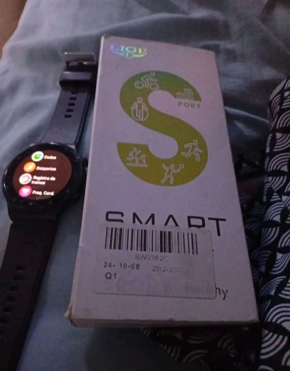 Smartwatch redondo lige com duas pulseiras 