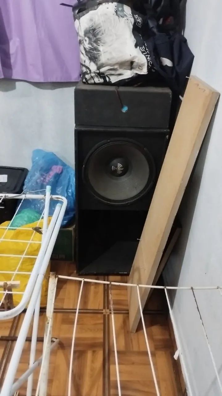 Caixa de som profissional e bateria.