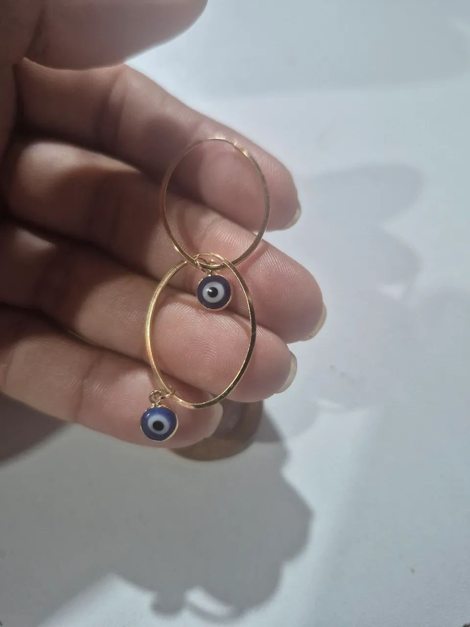 Vendo argola de ouro com pingentes de olho grego 