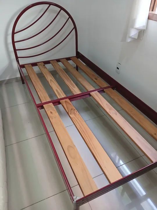 Cama de ferro com estrutura de madeira