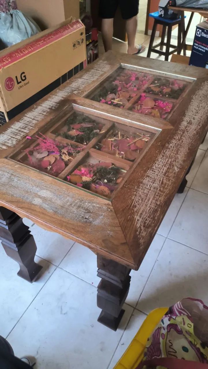 Mesa de madeira rústica e vidro com flores ornamentais 
