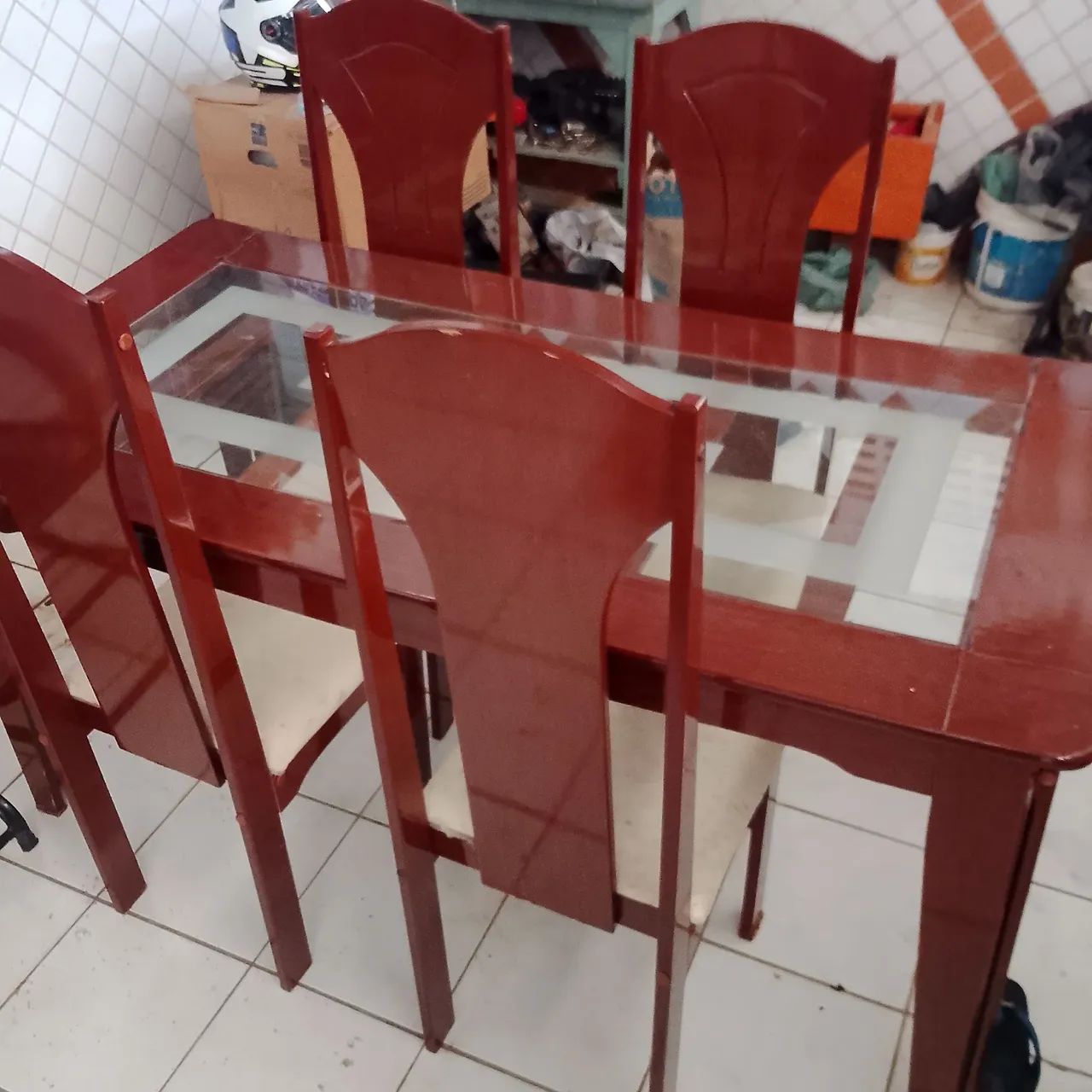 Uma mesa com quatro cadeiras e um criado mudo