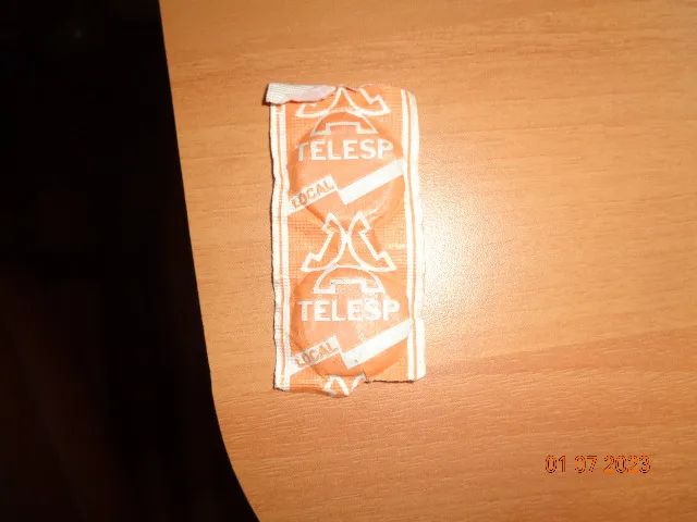 Pair of sealed street telephone tokens in the original envelope