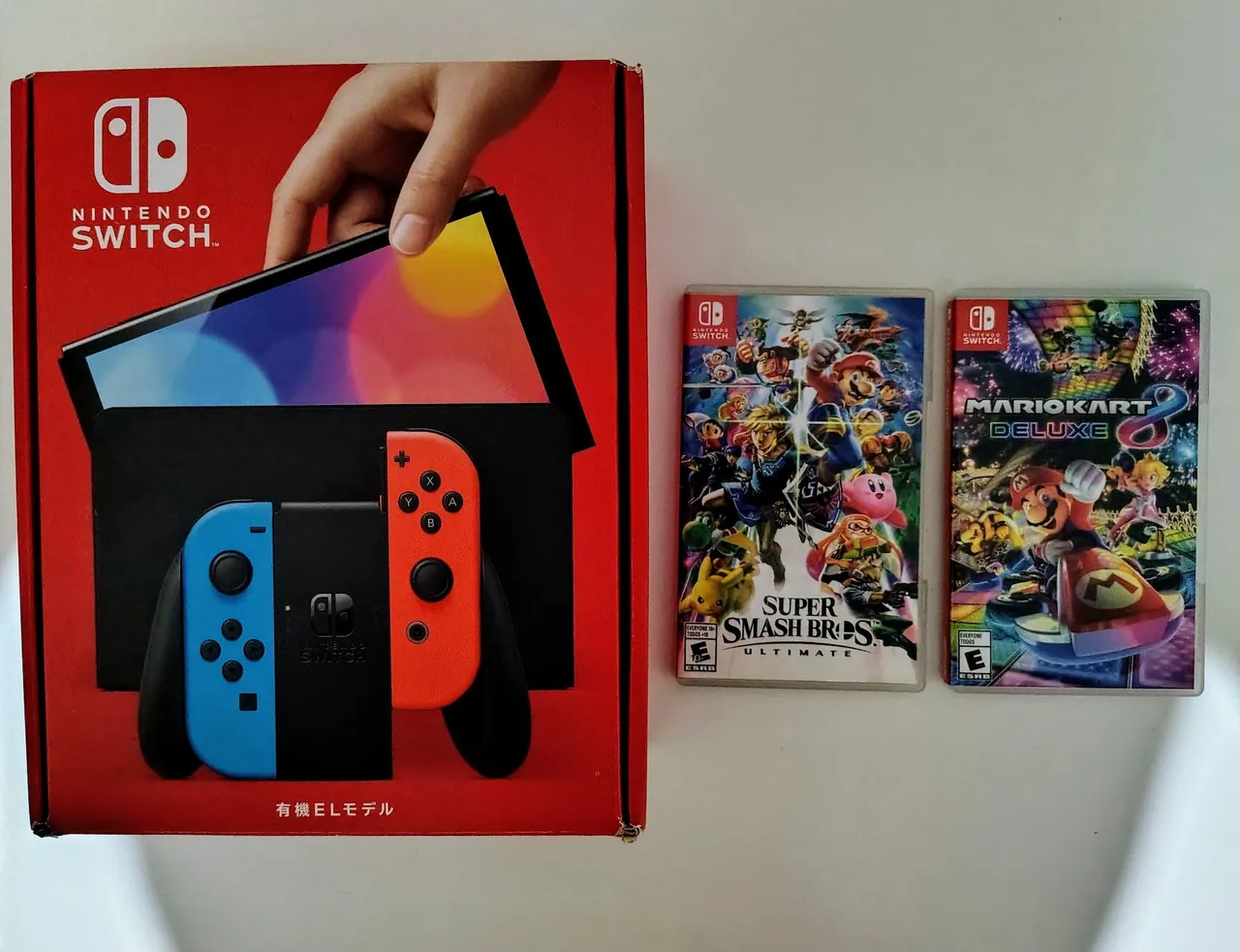 Nintendo Switch OLED + Super Smash Bros + Mario Kart 8 Deluxe