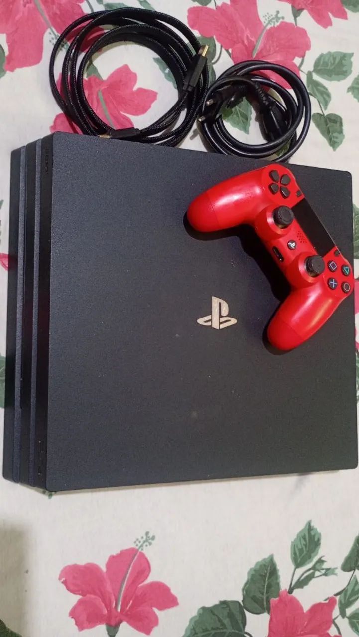 PlayStation 4 Pro com controle e jogos