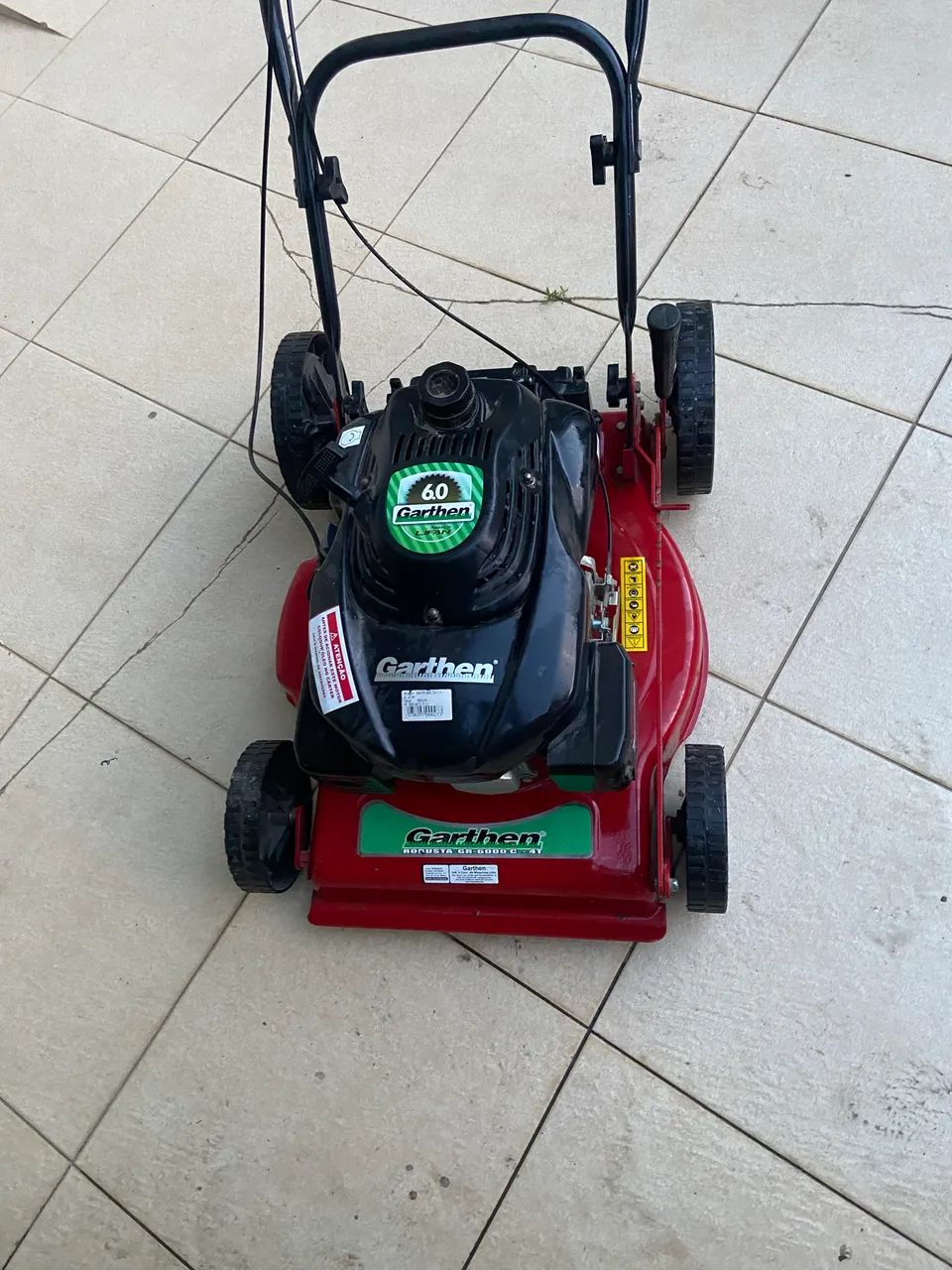 Gasoline-powered lawn mower.