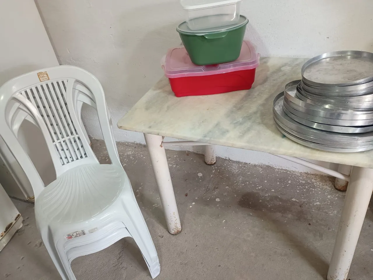 Cadeiras, formas de pizzas e potes de plástico