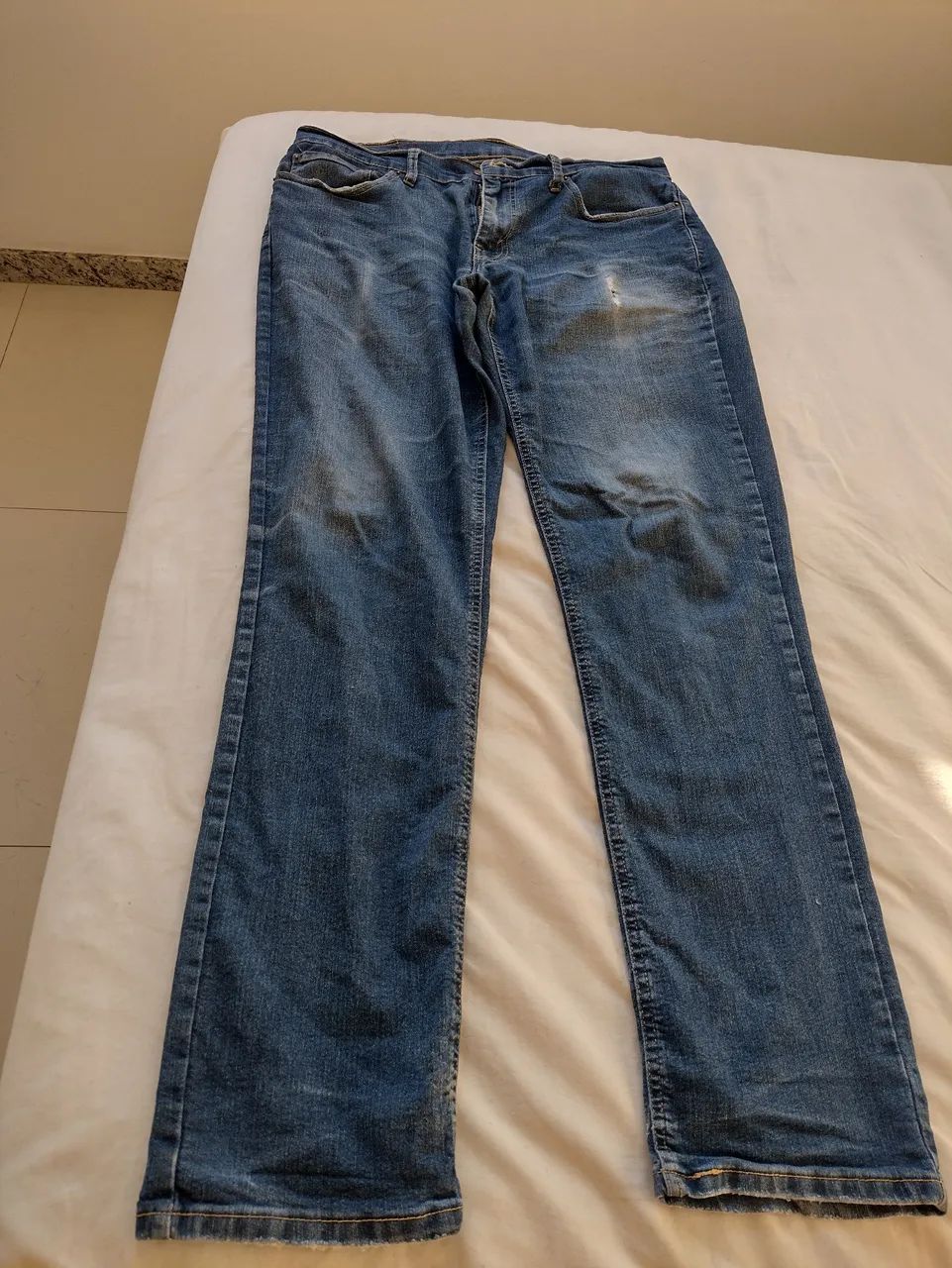 Calça Levi's jeans azul masculina pequeno rasgado perna direita 