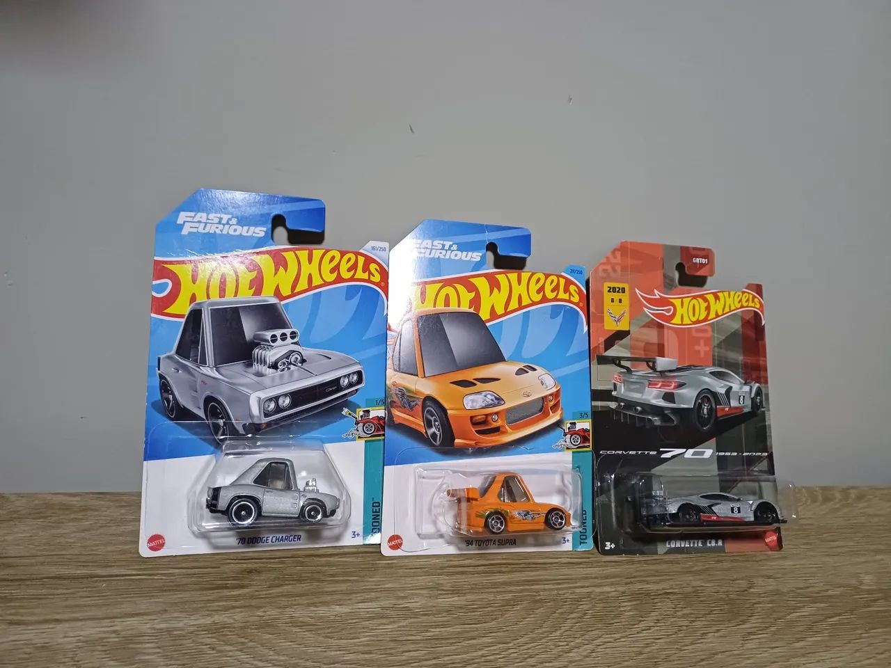 3 hotwheels 94 toyota supra tooned, 70 dodge charger, corvette c8