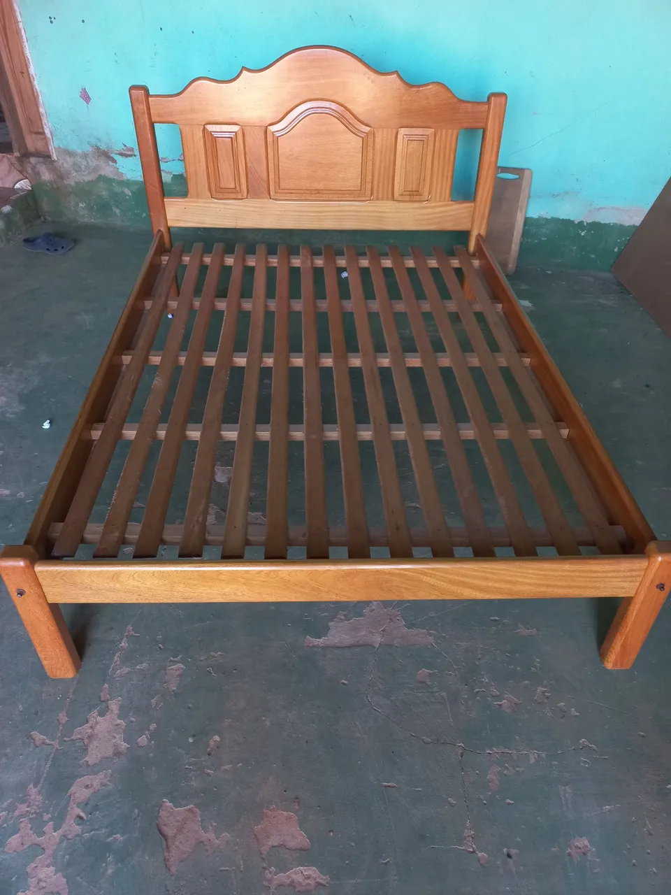 Cama de madeira com cabeceira trabalhada