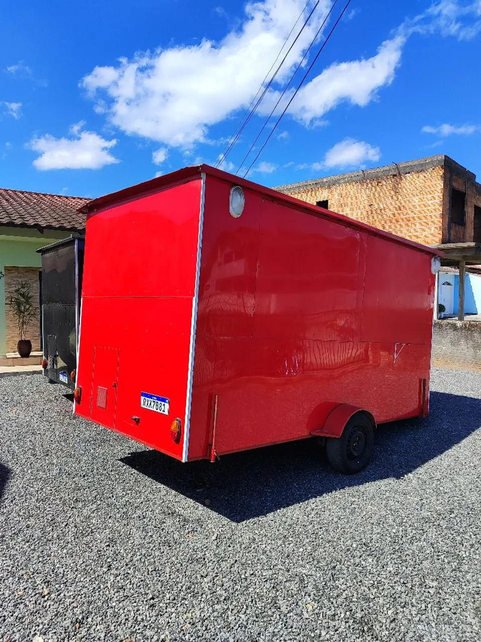 A person inspecting a trailer, symbolizing the thorough research and inspection that precedes a well-informed rental decision