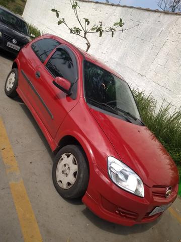 Celta GM Chevrolet vermelho - abaixo tabela