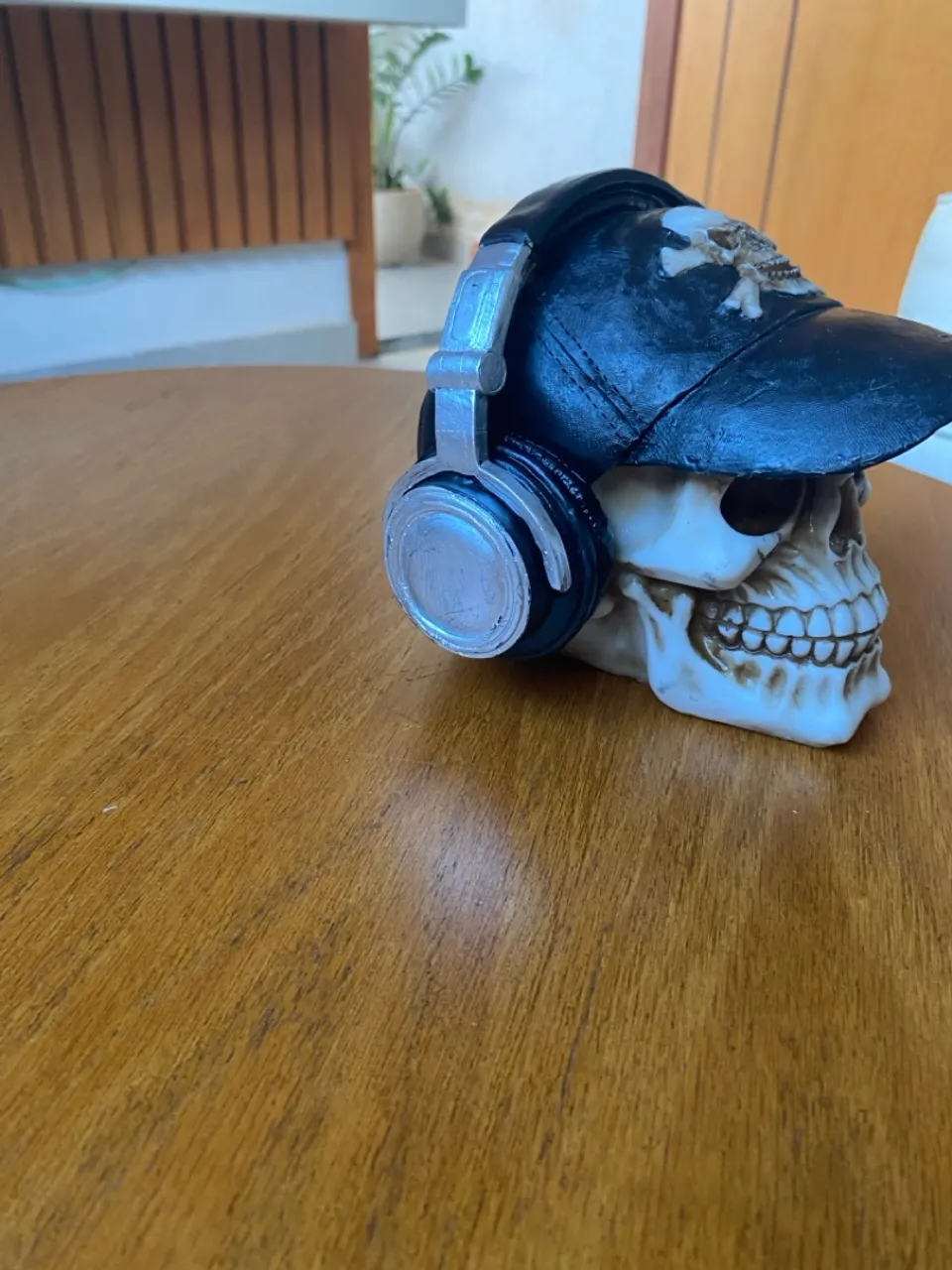 Escultura de Caveira com Boné e Fone de Ouvido