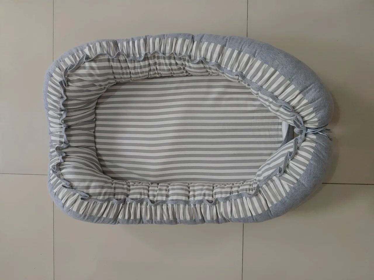 Ninho redutor de berço com ajuste