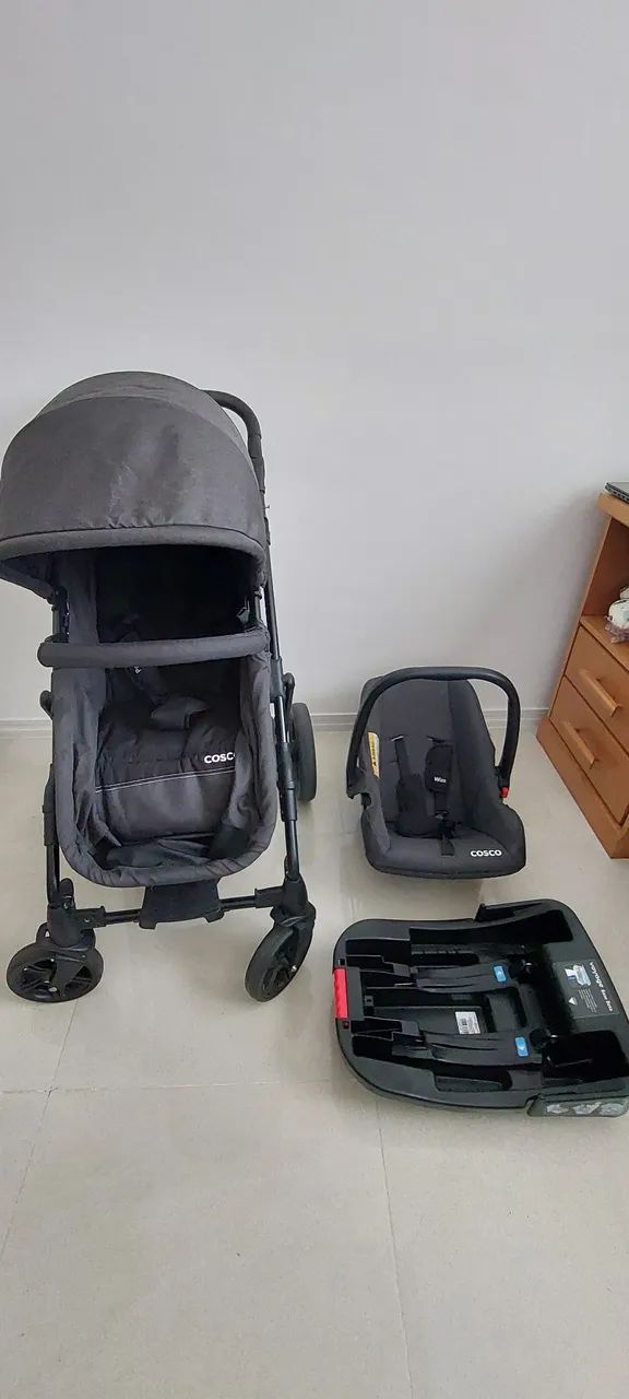 Carrinho de bebê com bebê conforto e base