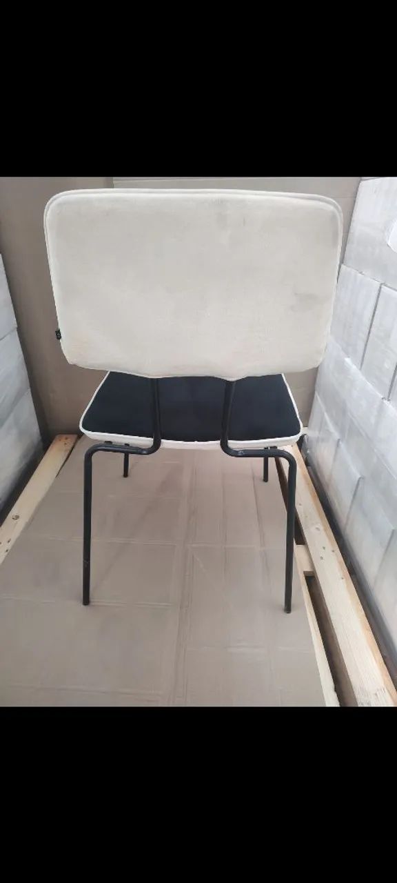 Cadeira estofada com pés de metal. Cor preta com bege.