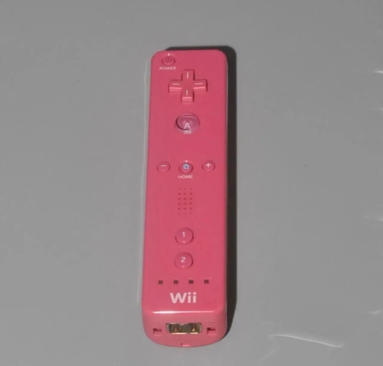 Controle original Nintendo Wii remote rosa.
