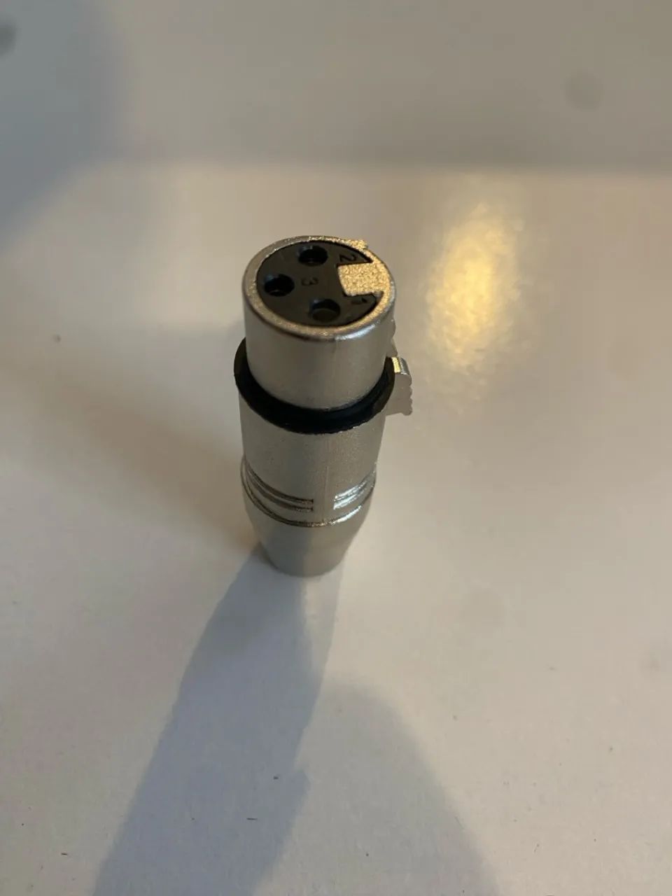Adaptador XRL 3 pinos fêmea pra 3.5mm fêmea.