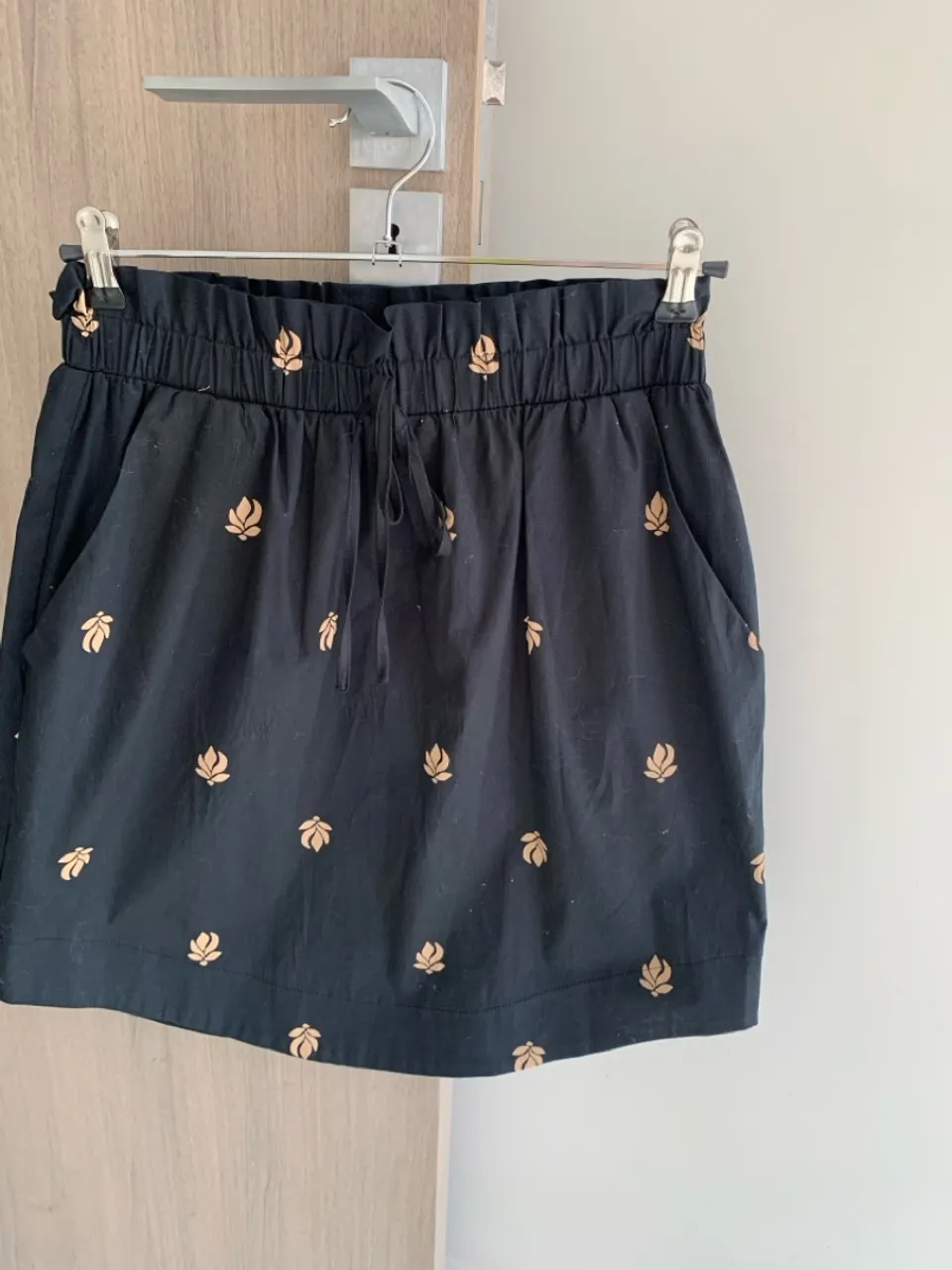 Saia preta com detalhes dourados M