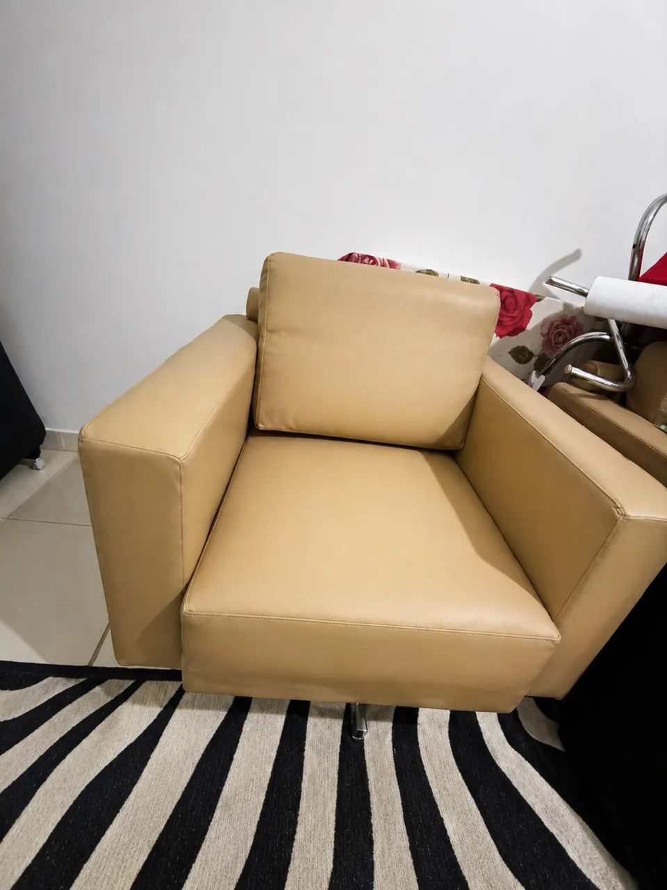 Caramel-colored armchairs with chrome swivel legs