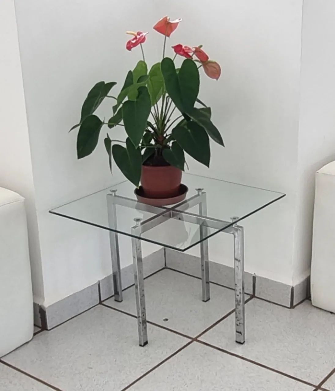 Mesa de canto com estrutura cromada e tampo de vidro