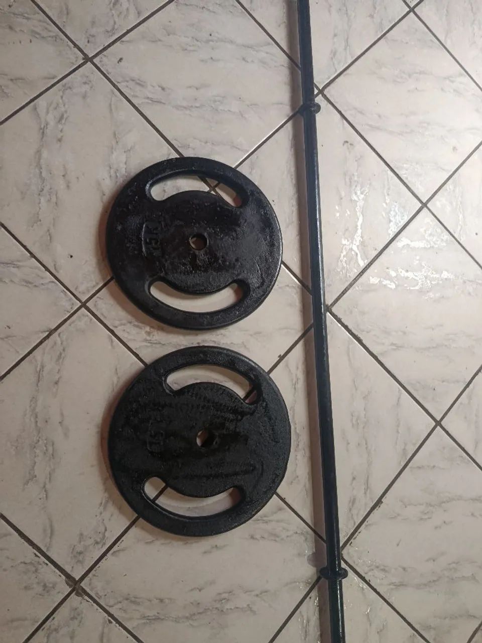 Duas anilhas de 15 kilos e uma barra 