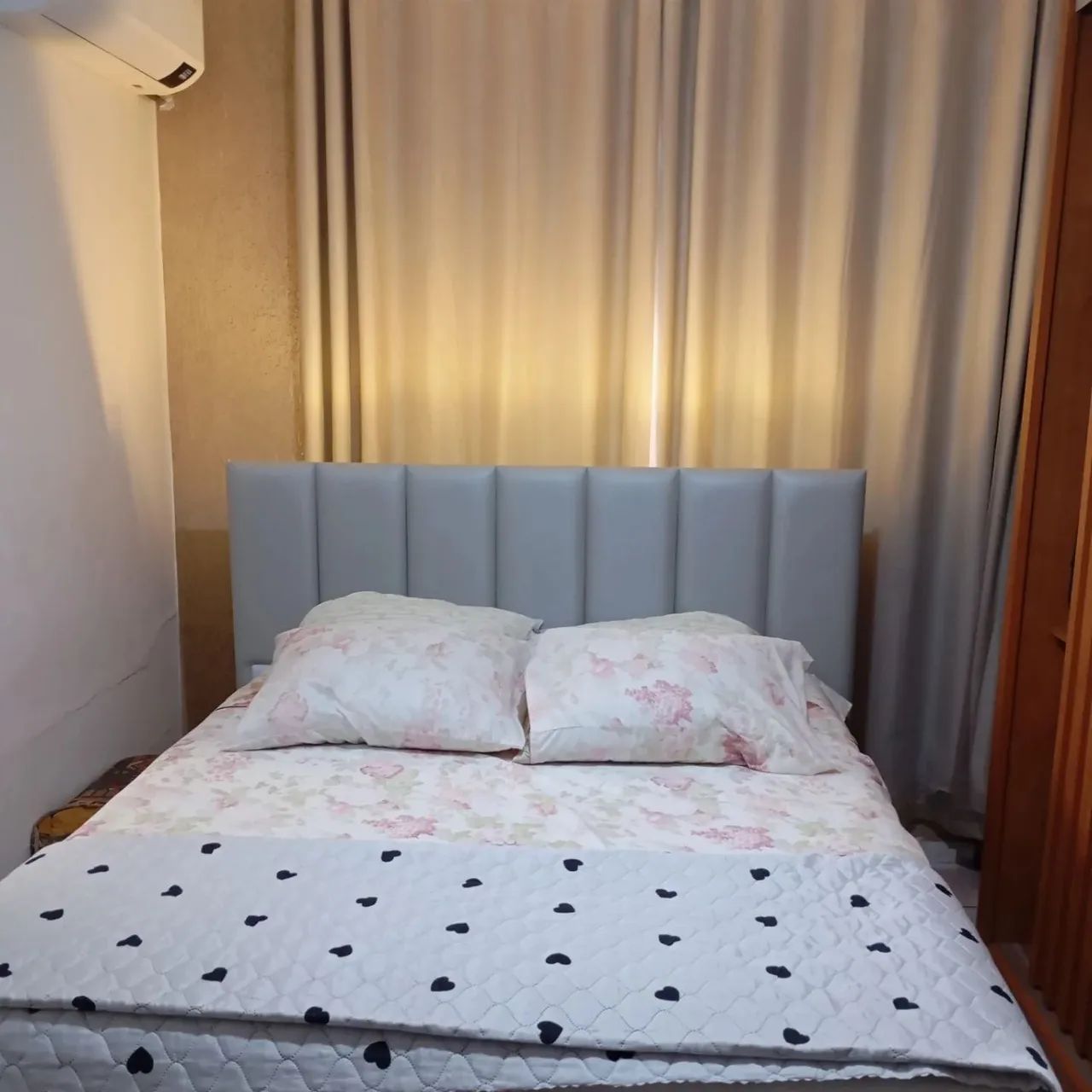 Linda cabeceira de cama estofada na cor rosa, com design moderno e elegante.