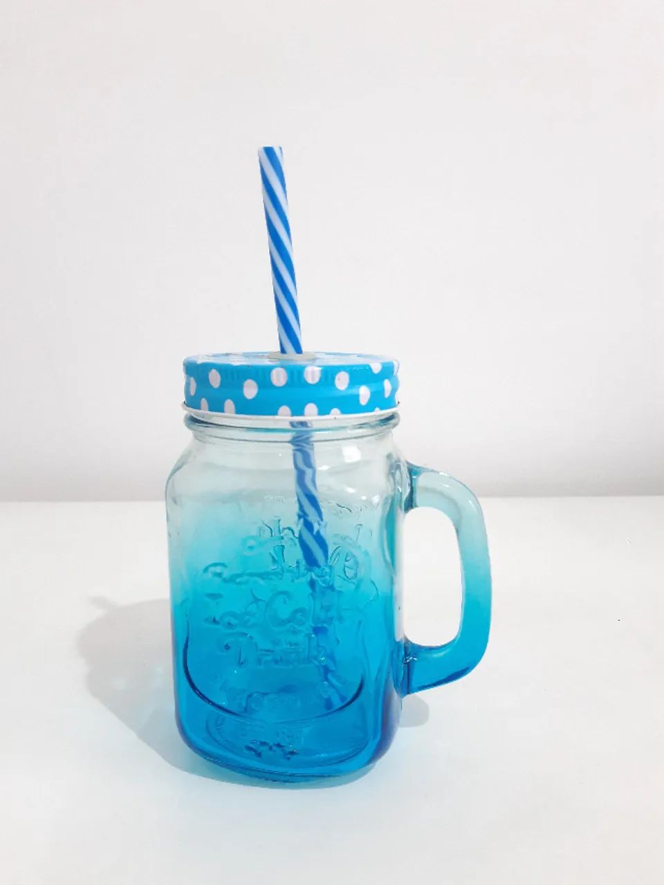 Retro glass mug with straw and blue lid