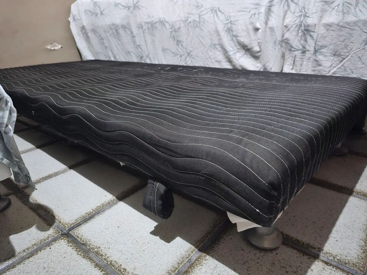 Cama auxiliar solteiro com colchão integrado.