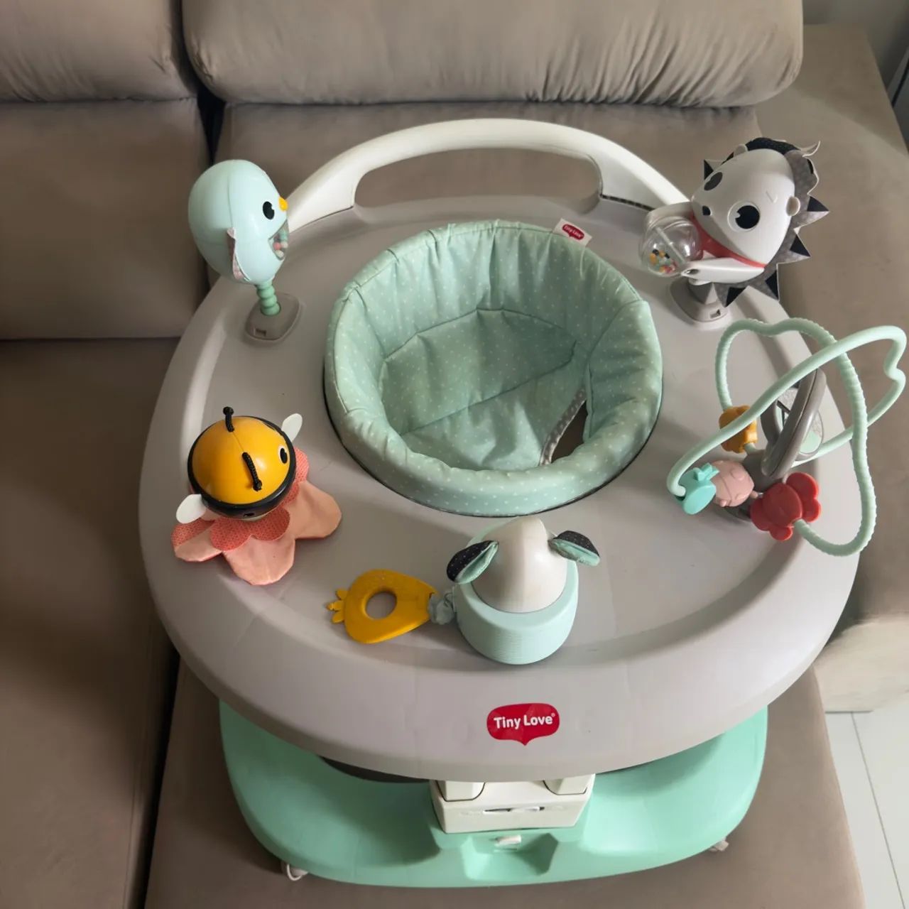 Andador Tiny Love com ajuste de altura e amortecedores.