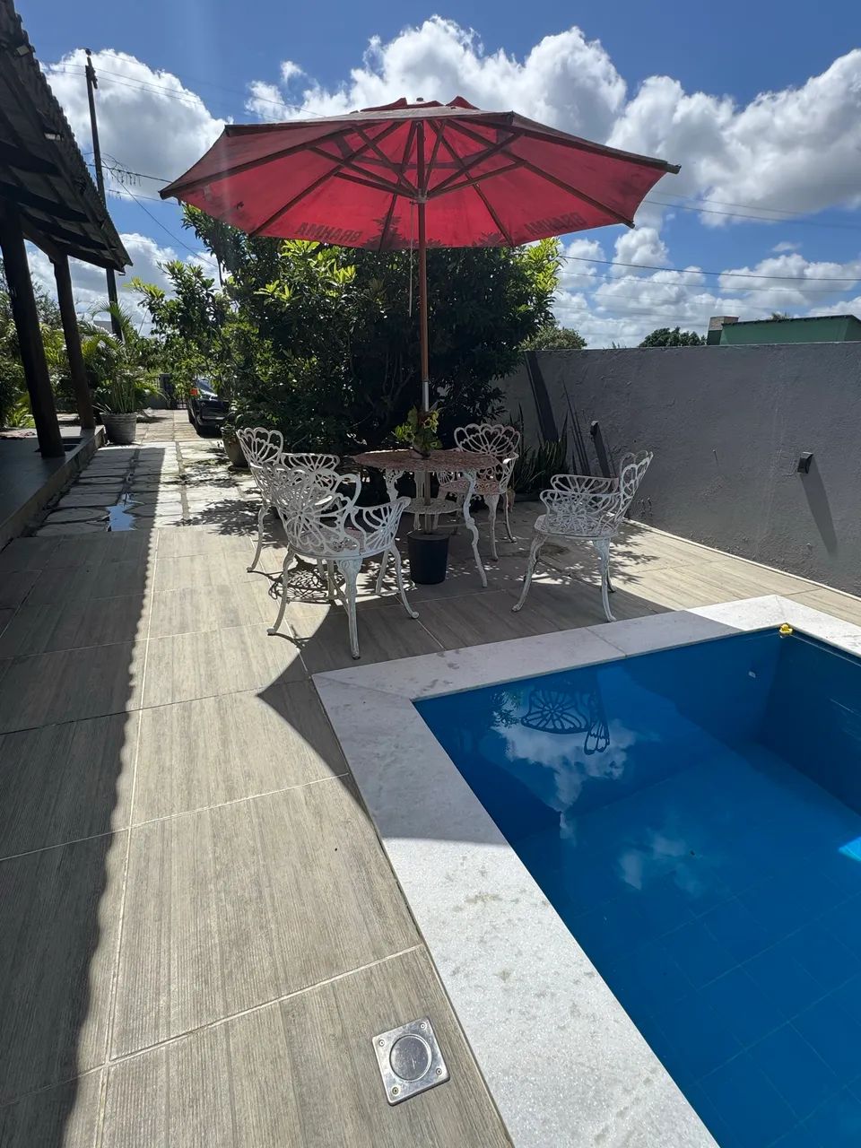 Mesa com quatro cadeira de jardim