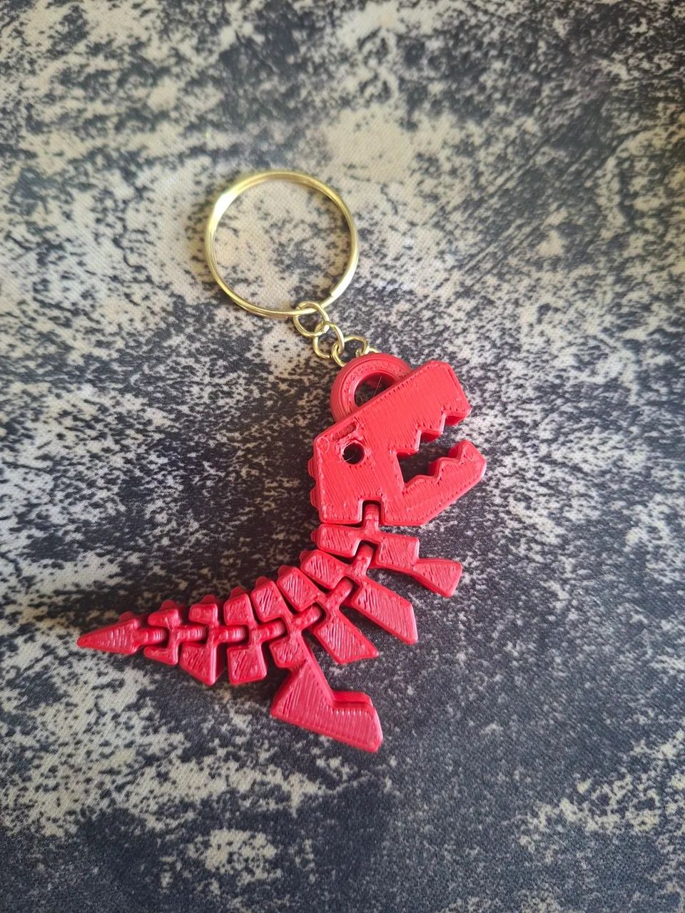 Chaveiro articulado de dinossauro 