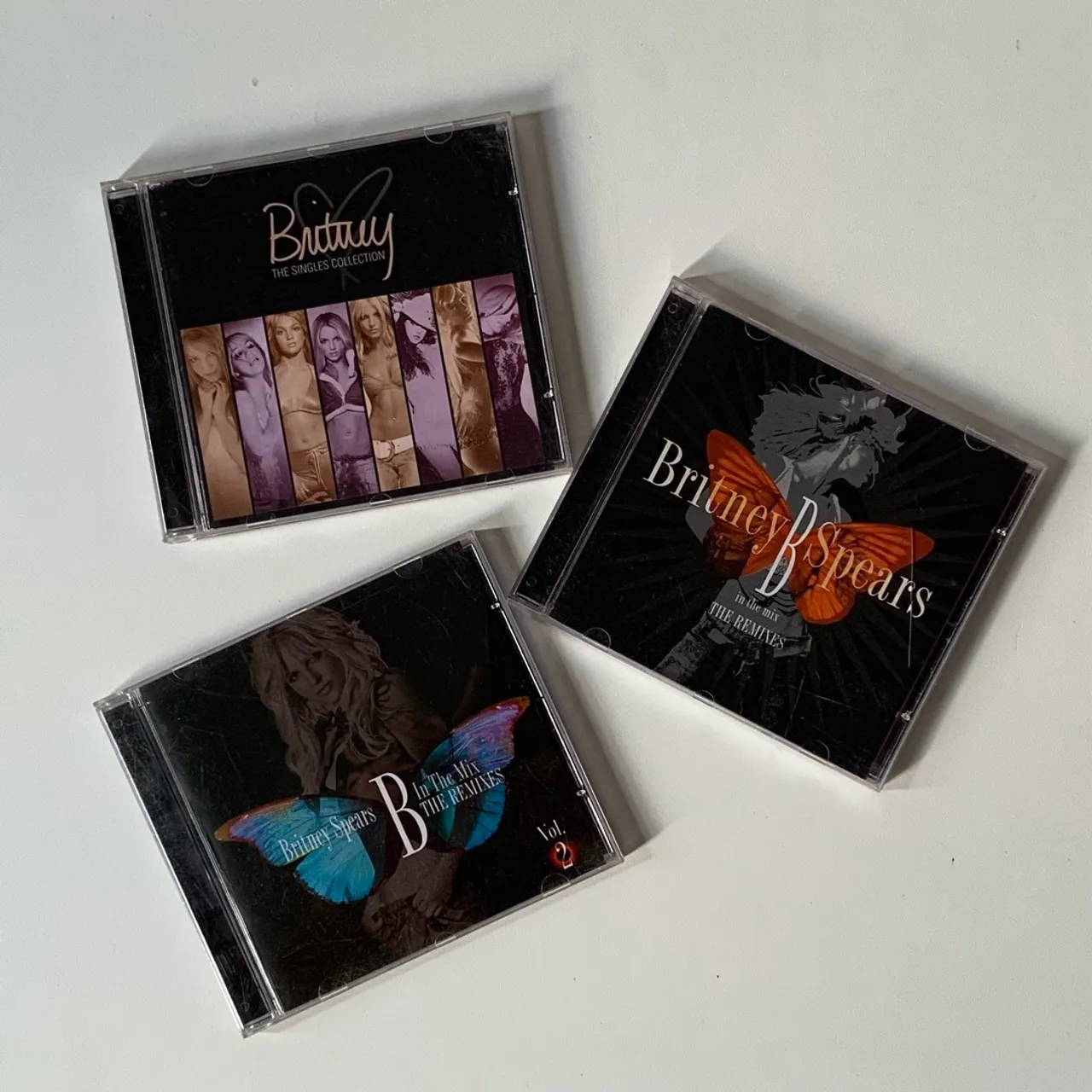 CDs Britney Spears Singles Collection e Remixes