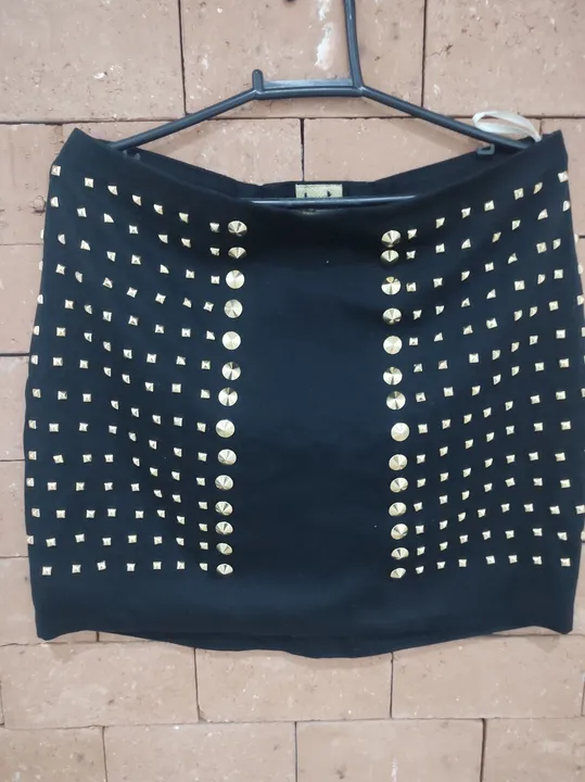 Saia preta com tachas douradas