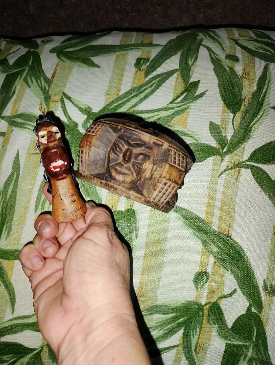 A miniature carranca and a wooden ashtray?